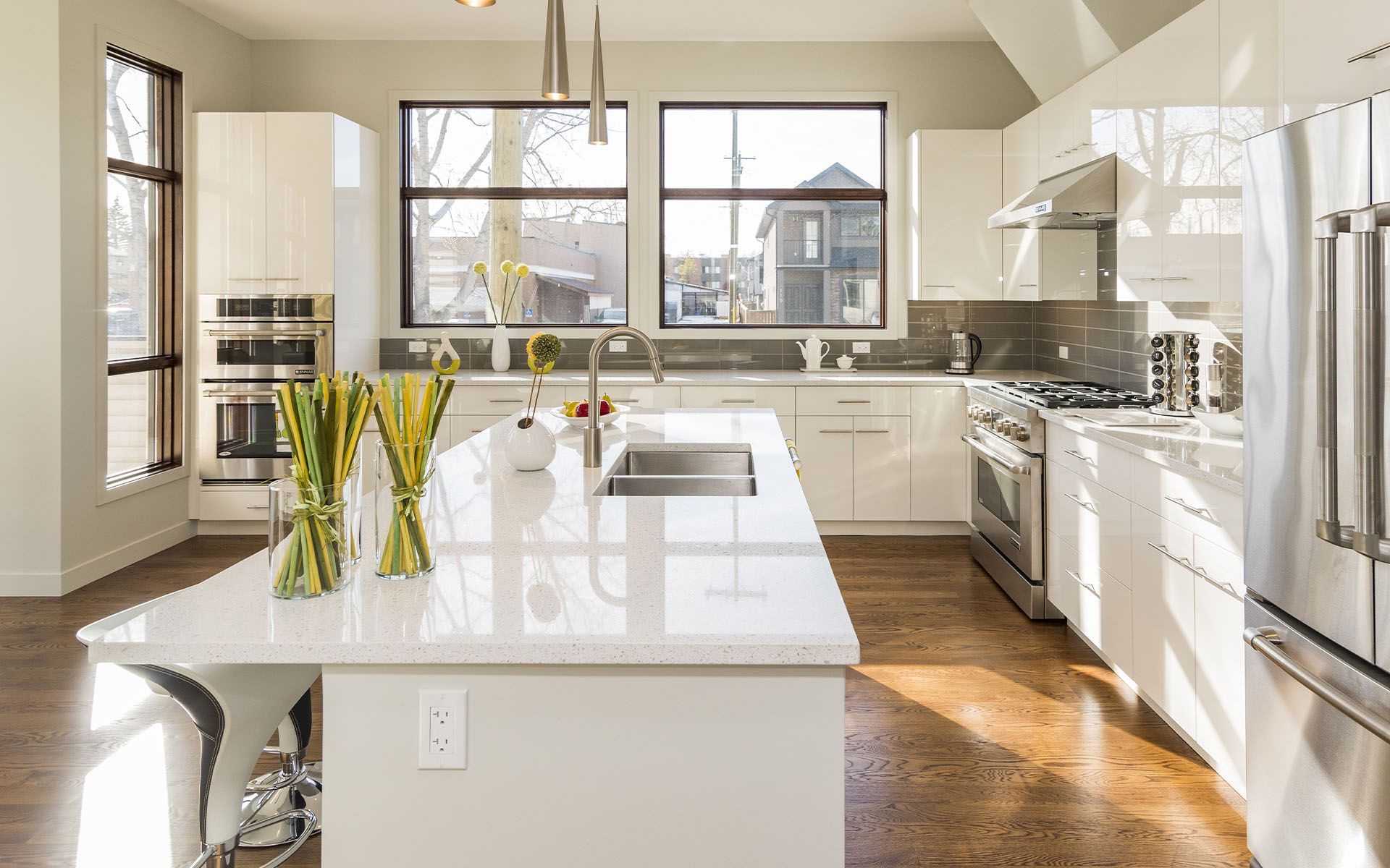 A Kitchen with White Cabinets and Stainless Steel Appliances and A Large Island in The Middle — Maid In Bowral in Moss Vale, NSW