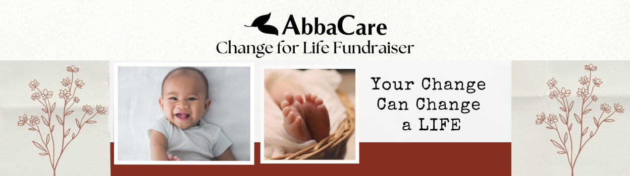 A baby is being held in a basket with the words