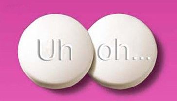 Two white pills with the words uh oh written on them on a pink background.