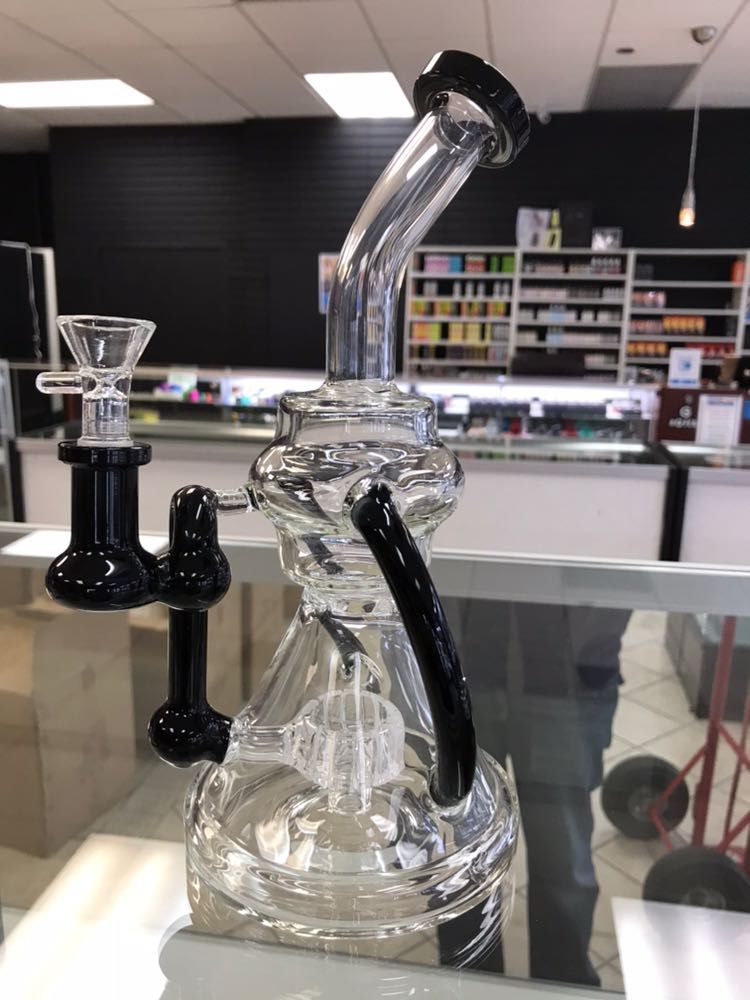 A glass pipe is sitting on a counter in a store