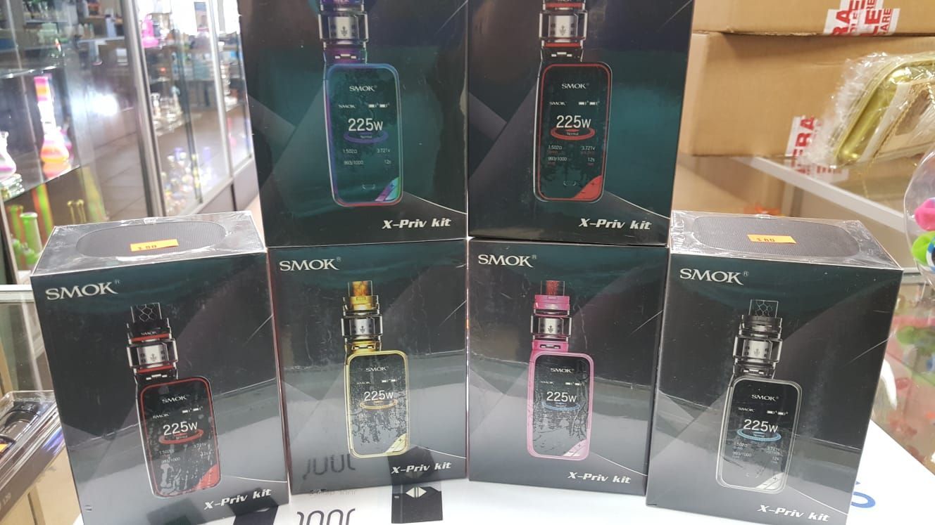 A group of electronic cigarettes are sitting on top of each other on a table