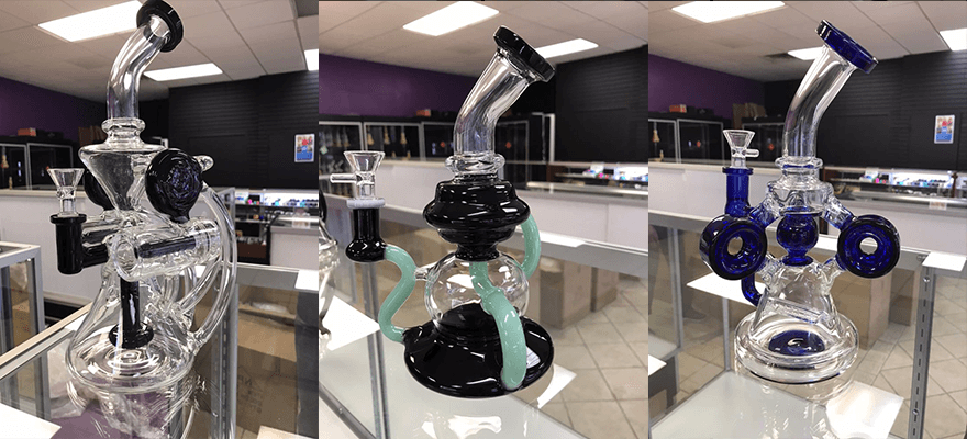 Three different types of bongs are sitting on a table in a store