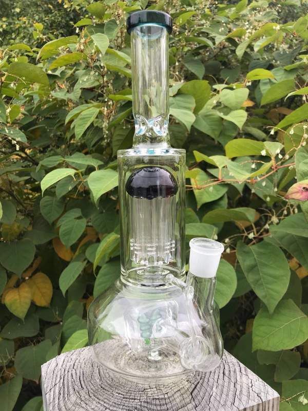 A glass bong is sitting on top of a wooden block