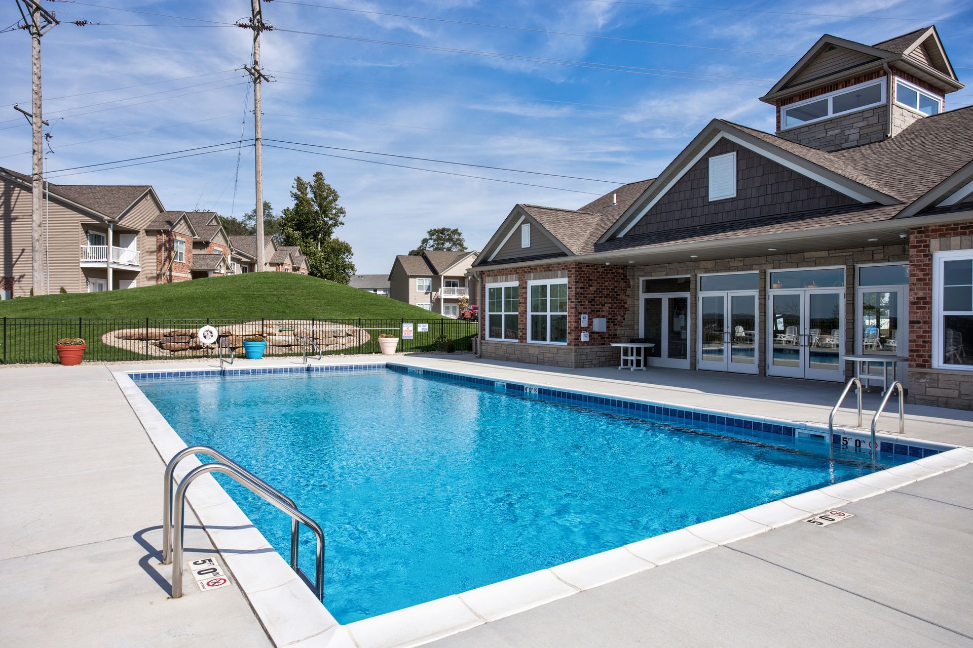 There is a large swimming pool in front of a building.
