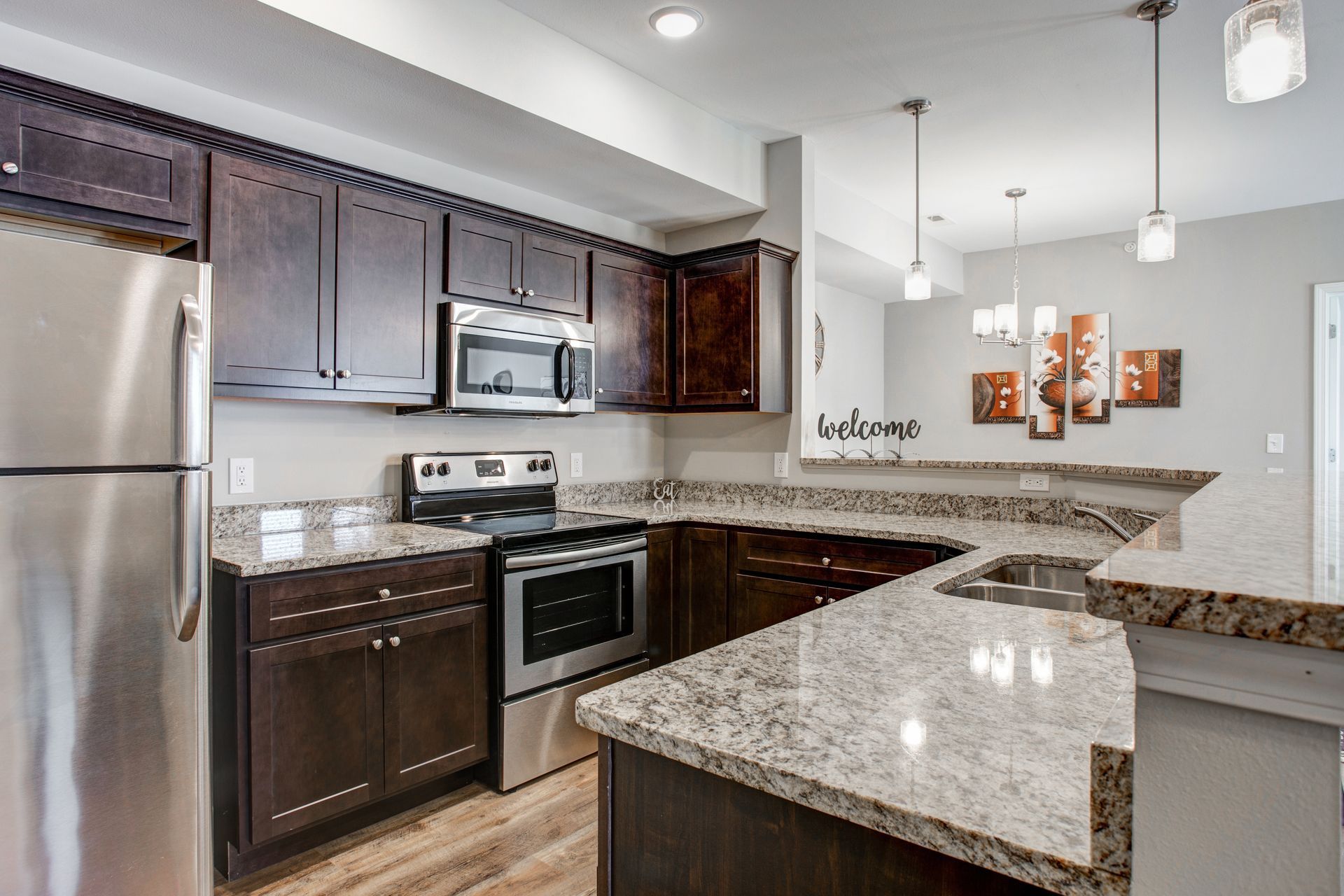 A kitchen with stainless steel appliances and granite counter tops.