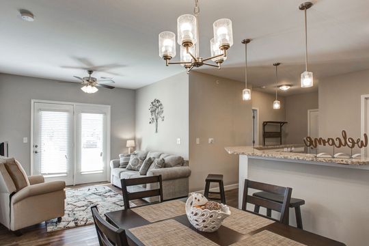 A living room with a dining room table and chairs