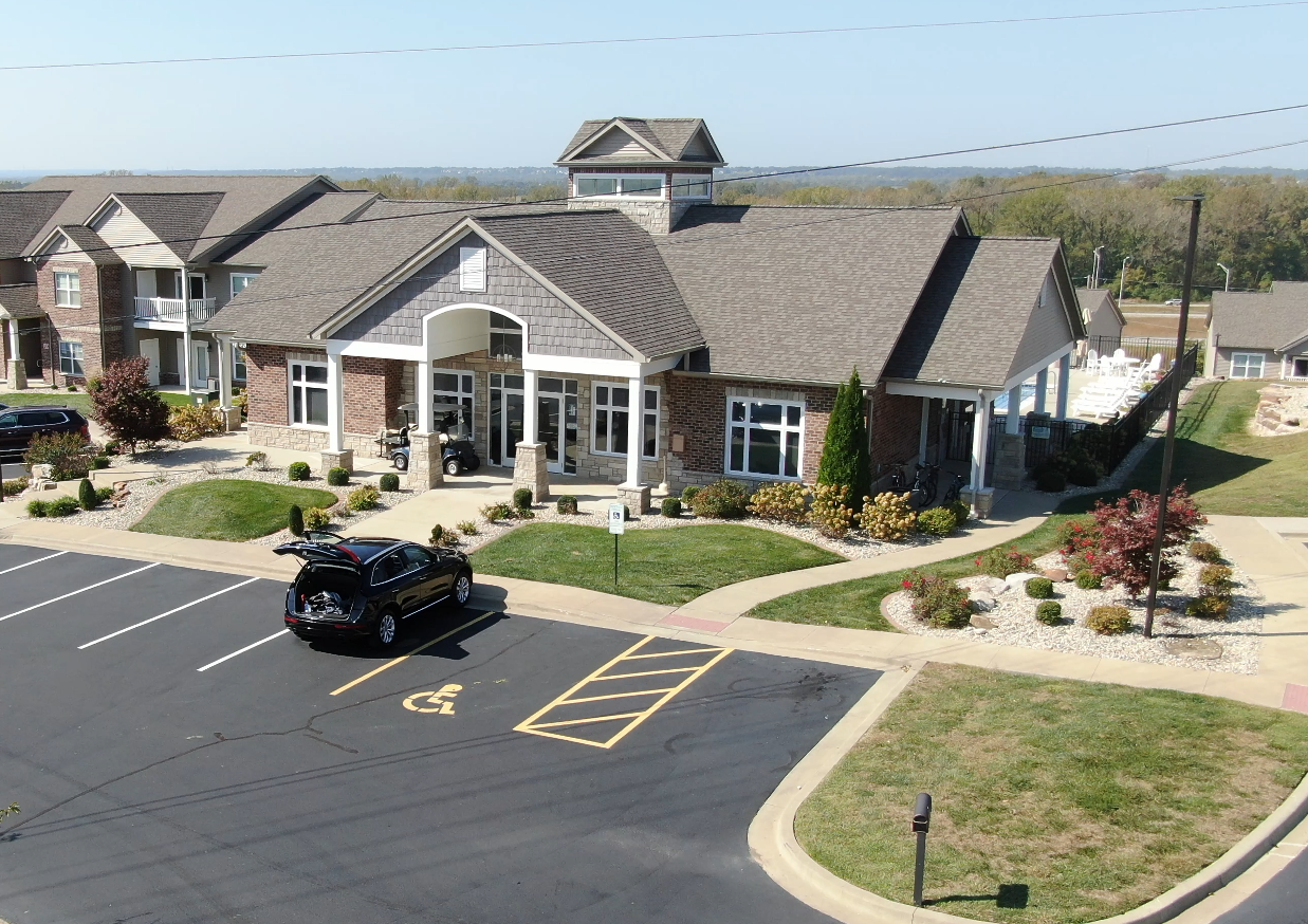 An aerial view of a building with a handicapped parking spot in front of it.