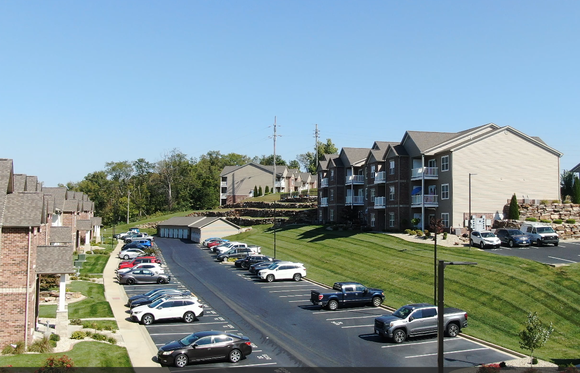 A parking lot with cars parked in front of a building
