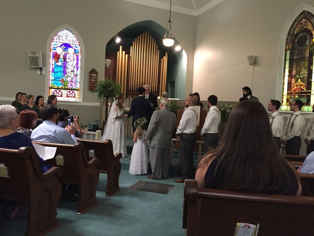 A bride and groom are getting married in a church