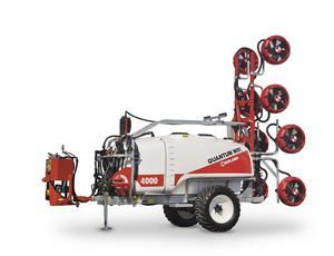 A white and red sprayer with a bunch of fans attached to it.