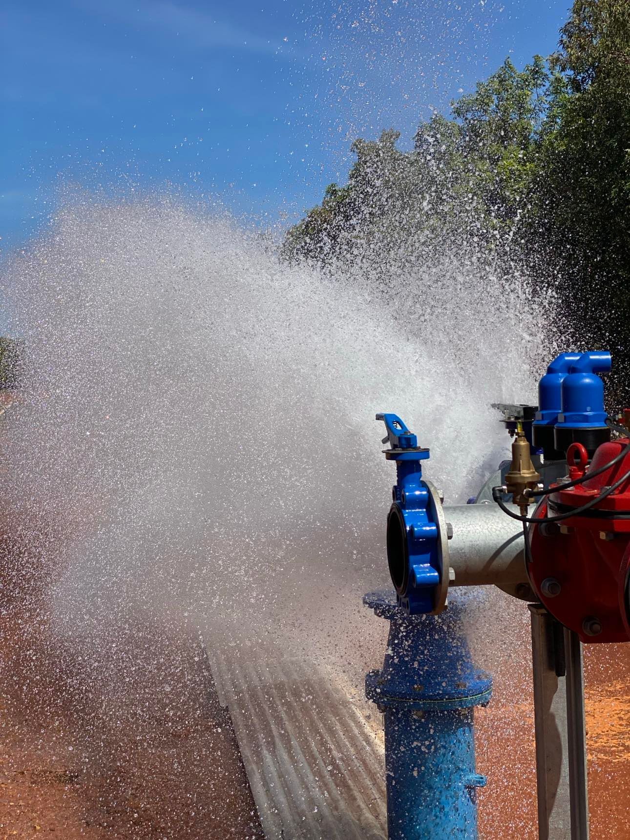 A blue pipe with water coming out of it