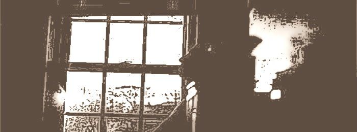 Lonely person looks out of window
