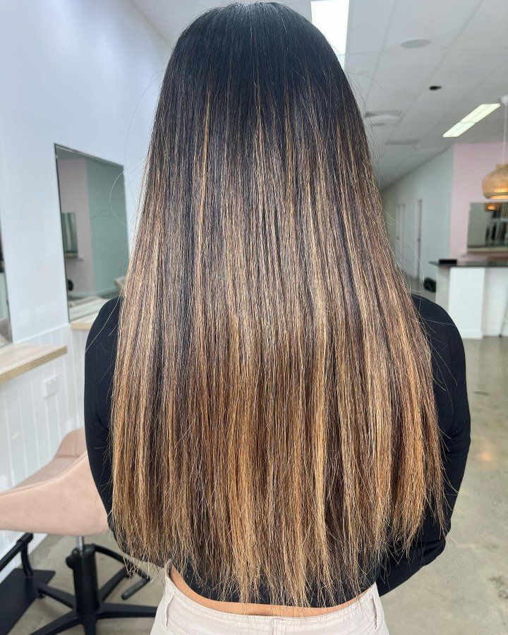 A Woman With Long Hair Is Standing In A Salon — The Hair Boutique Co In Varsity Lakes, QLD
