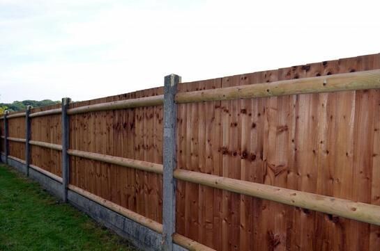 a newly made wooden log cedar fence