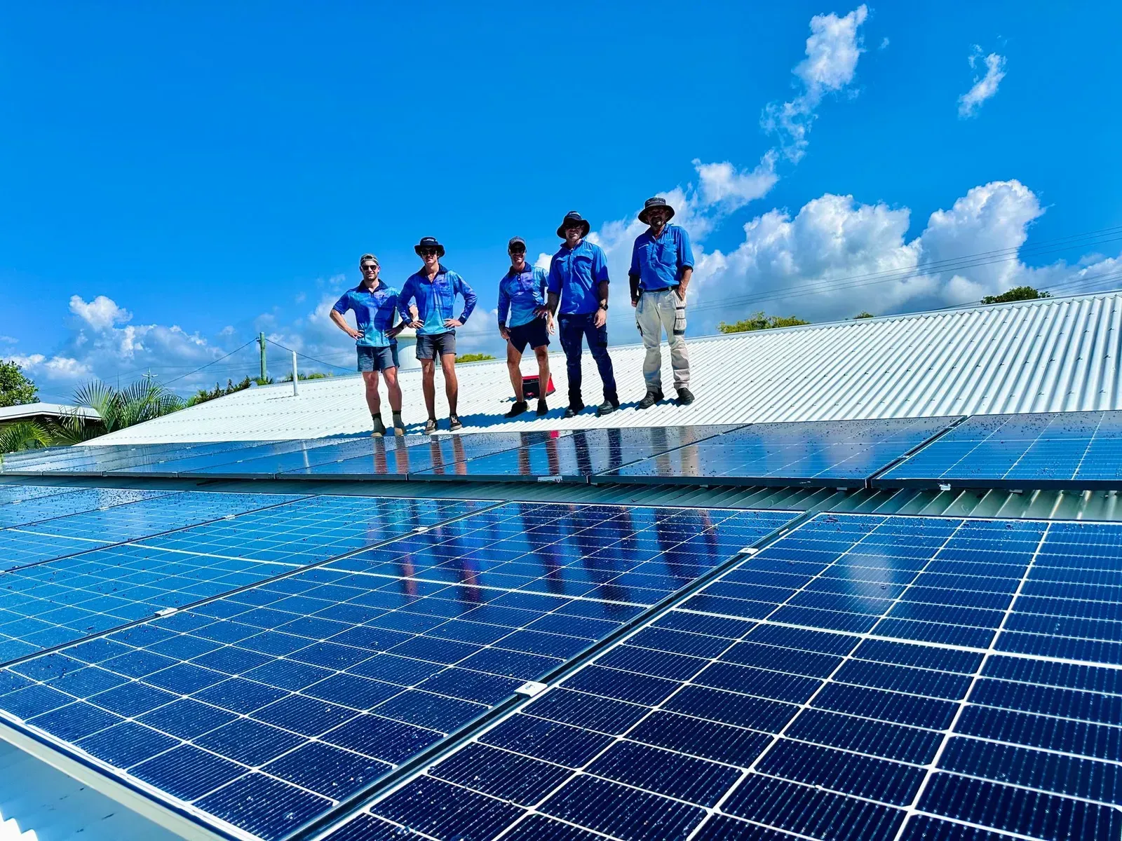 Solar Panel Installation on a Rooftop With a Team of Installers — Lahtinen Electrical & Refrigeration in Ingham, QLD