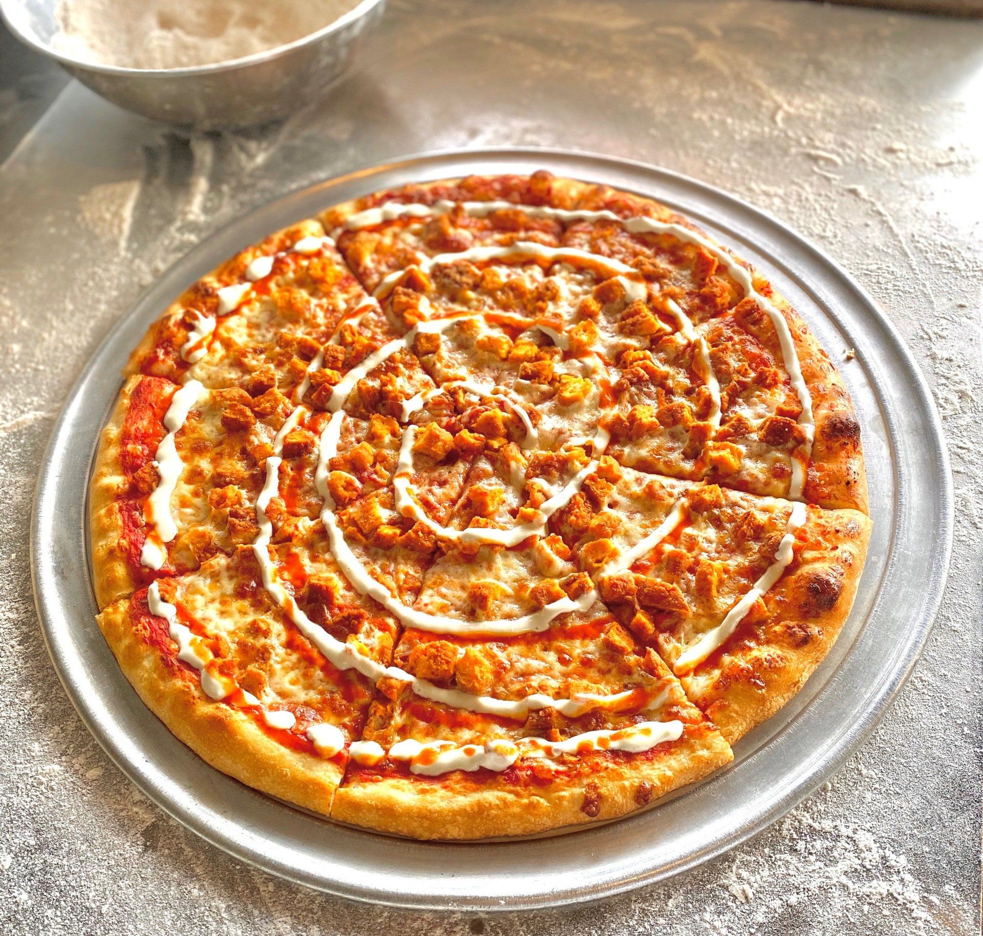 A pizza with a swirl of cheese on top of it