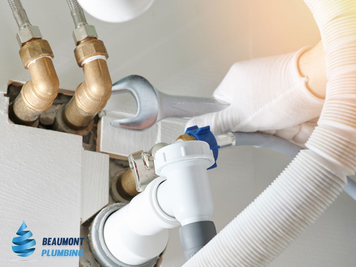 A Person is Fixing a Sink With a Wrench — Beaumont Plumbing in Glenfield Park, NSW