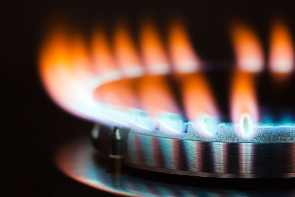 A Close Up of a Gas Burner With Flames Coming Out of It — Beaumont Plumbing in Glenfield Park, NSW