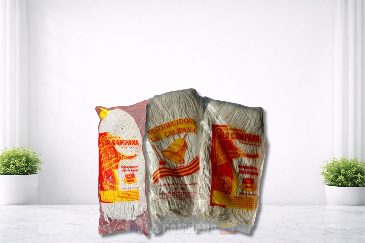 Three colorful snack packages standing upright on a white tabletop with small green plants on each side