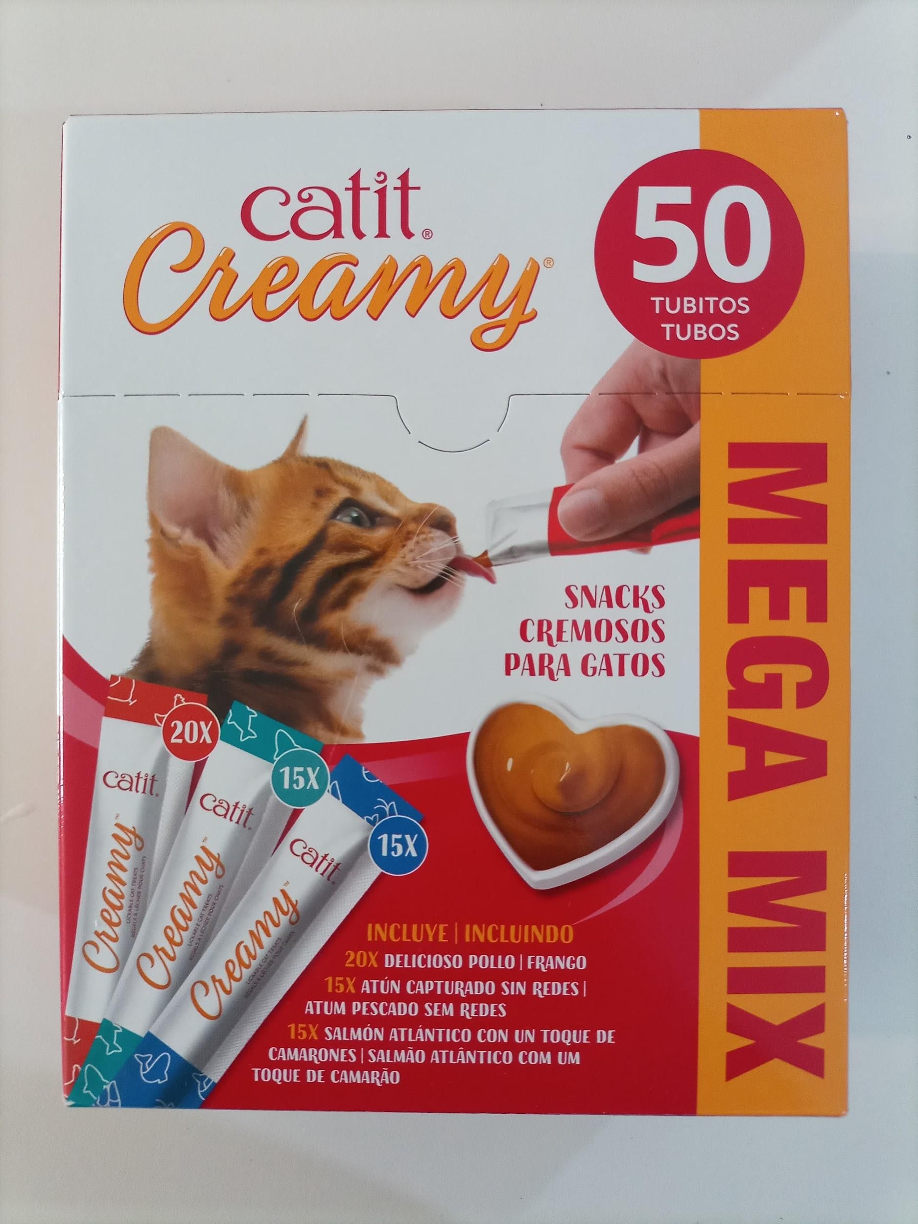 Caja de golosinas para gatos, “Catit Creamy” con un gato comiendo de un tubo, una golosina en forma de corazón.