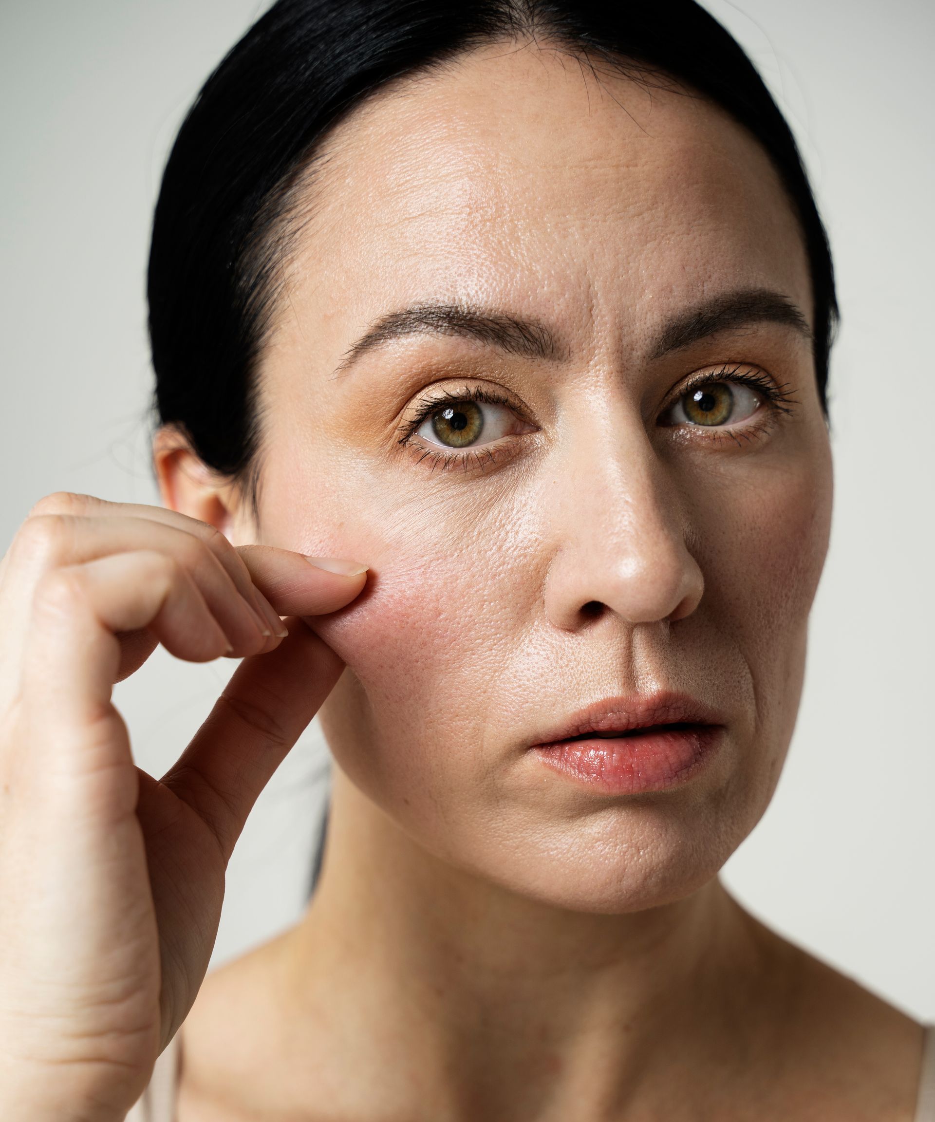 woman holding her cheek