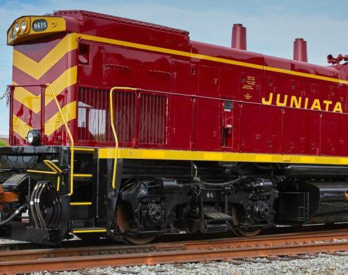 Red and yellow JUNIATA locomotive on tracks, side view