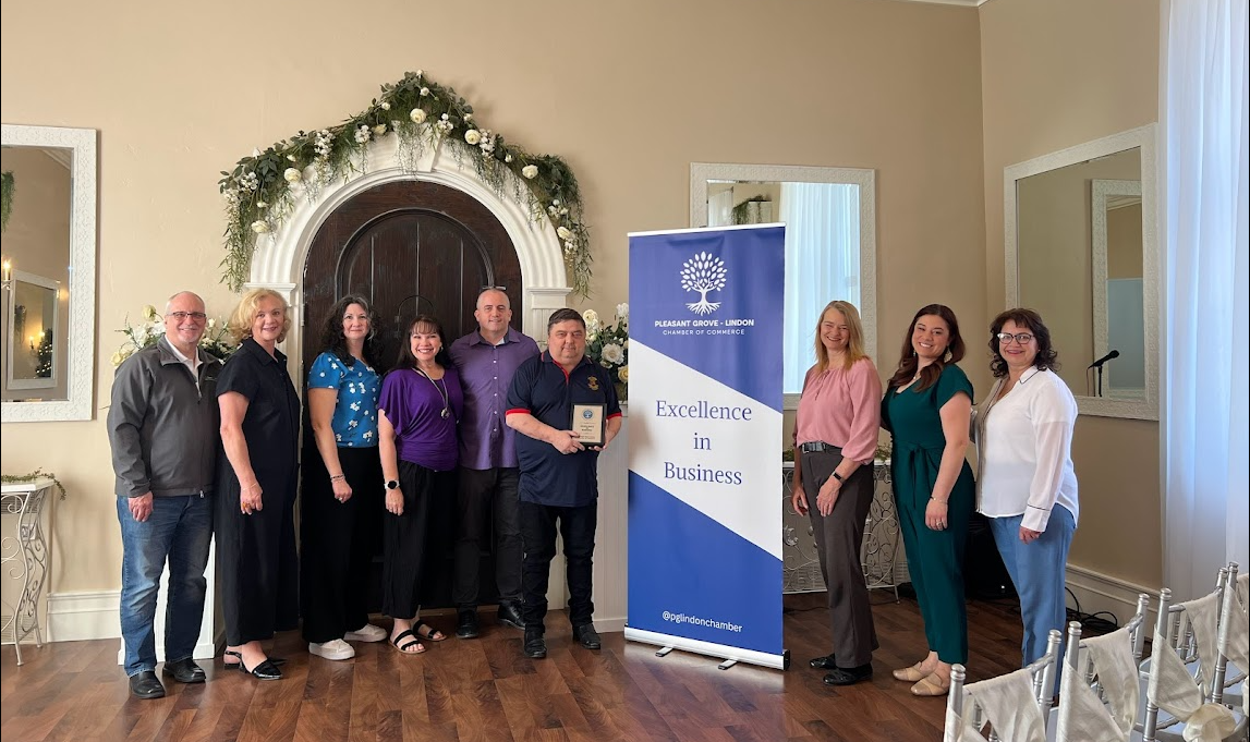 A group of people are posing for a picture in a room.