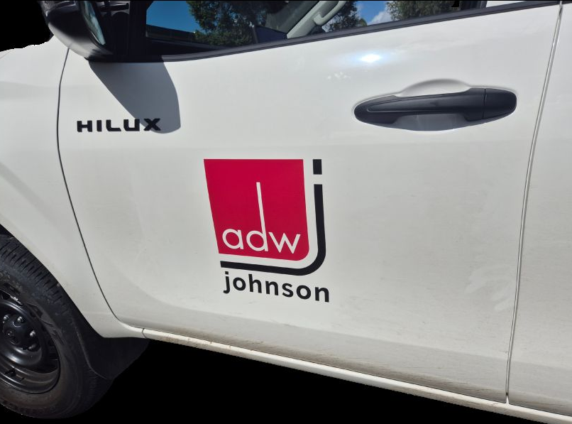 White Utility Truck Door With Red “ADW Johnson” Logo — Al's Custom Prints in Wyong, NSW