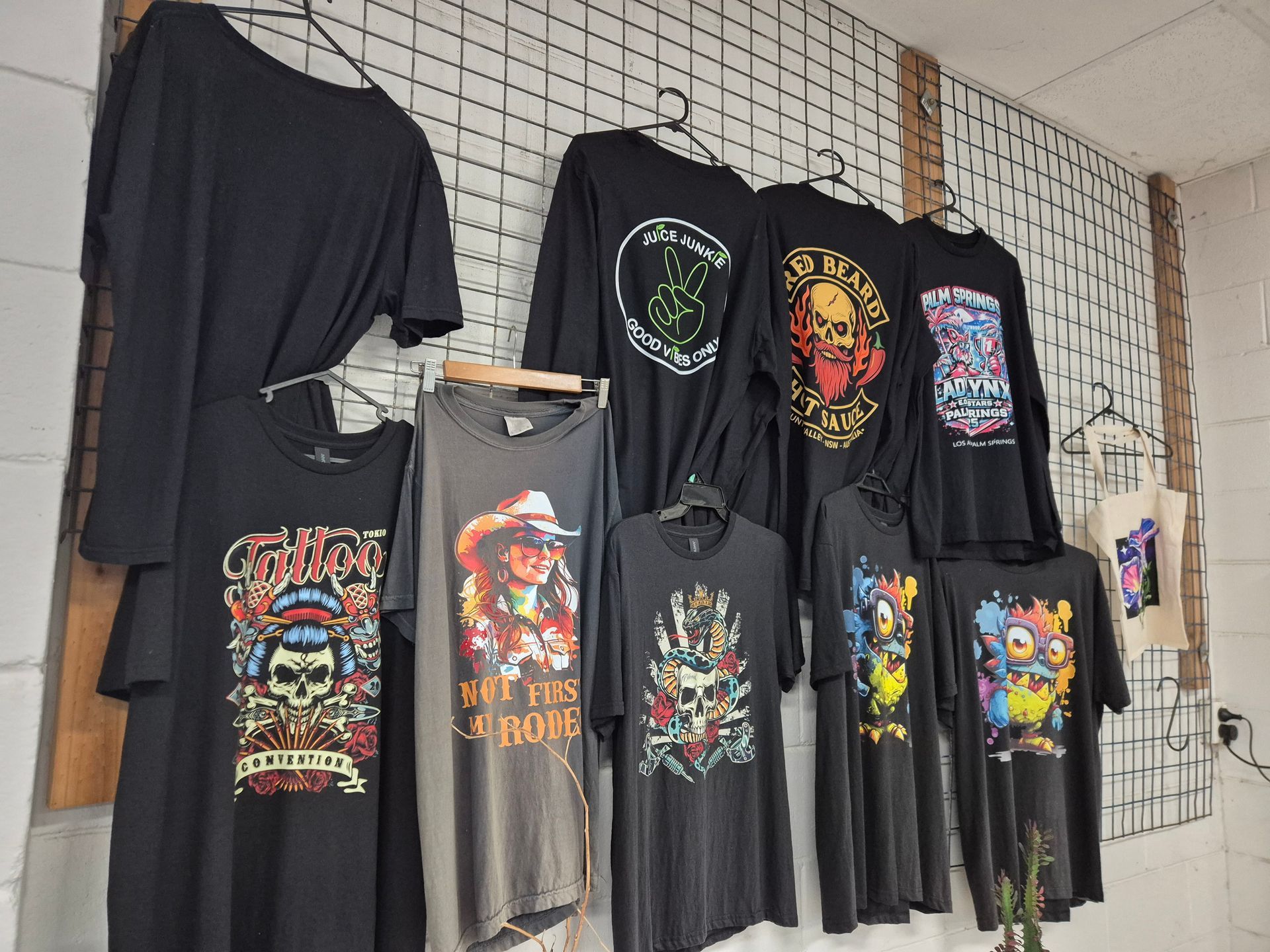 Hand Pressing a Heat Press Onto a White Shirt on a Worktable — Al's Custom Prints in Wyong, NSW 