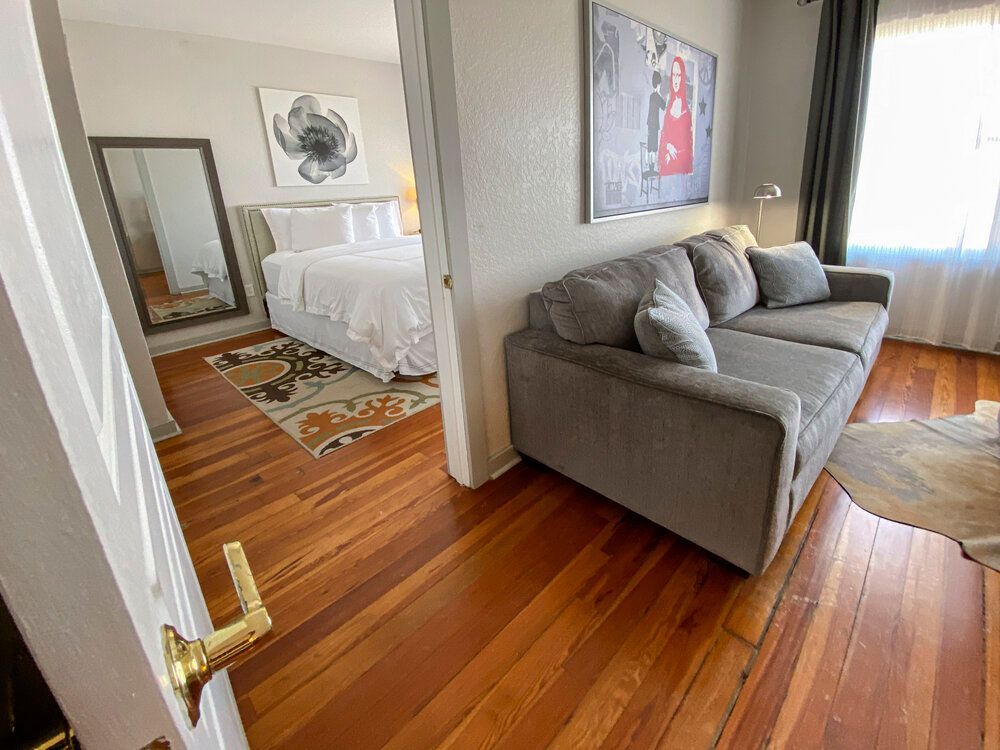 A living room with a couch and a bed.