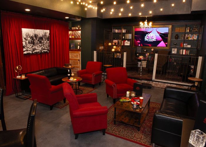 A living room with red chairs and a couch