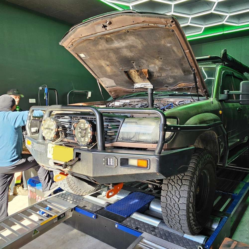 Dark Green 4x4 With Hood Up on a Dyno, Mechanics — Greens Diesel Tune in Camden, NSW