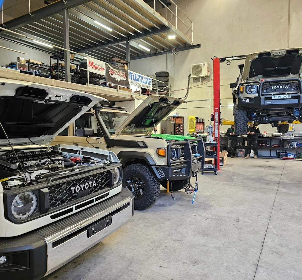 Several Cars in a Mechanic's Shop, One on a Lift, Hoods Open for Repair — Greens Diesel Tune in Campbelltown, NSW