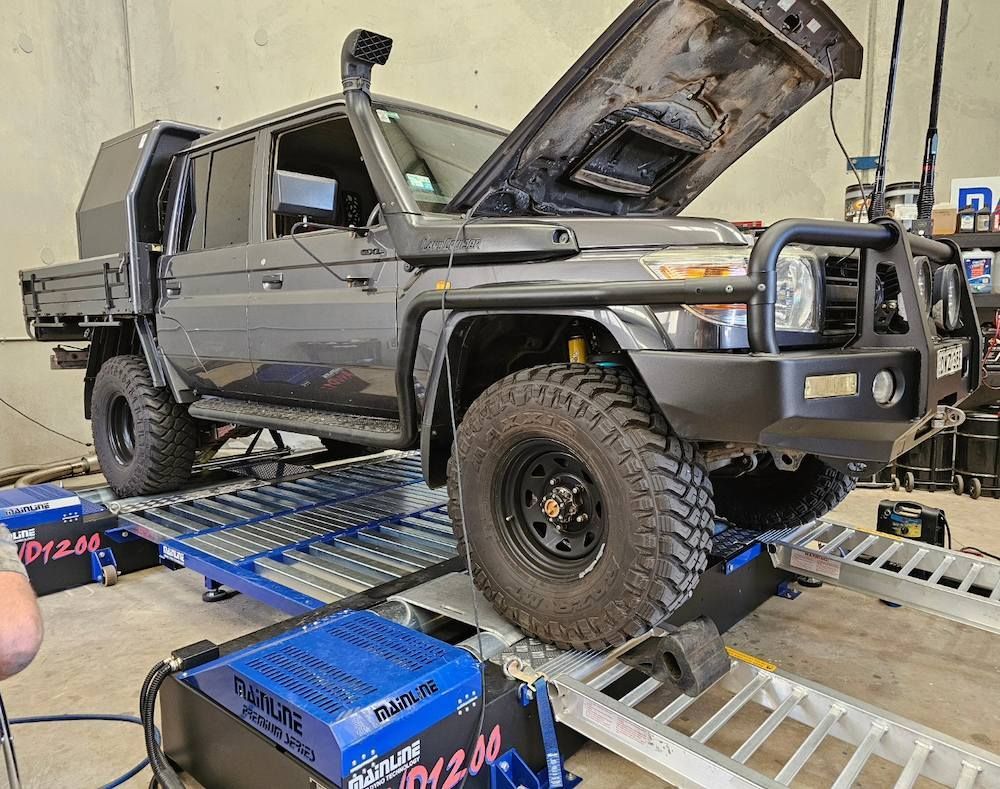 Dark Gray 4x4 Truck on a Dyno With Hood Open — Greens Diesel Tune in Smeaton Grange, NSW
