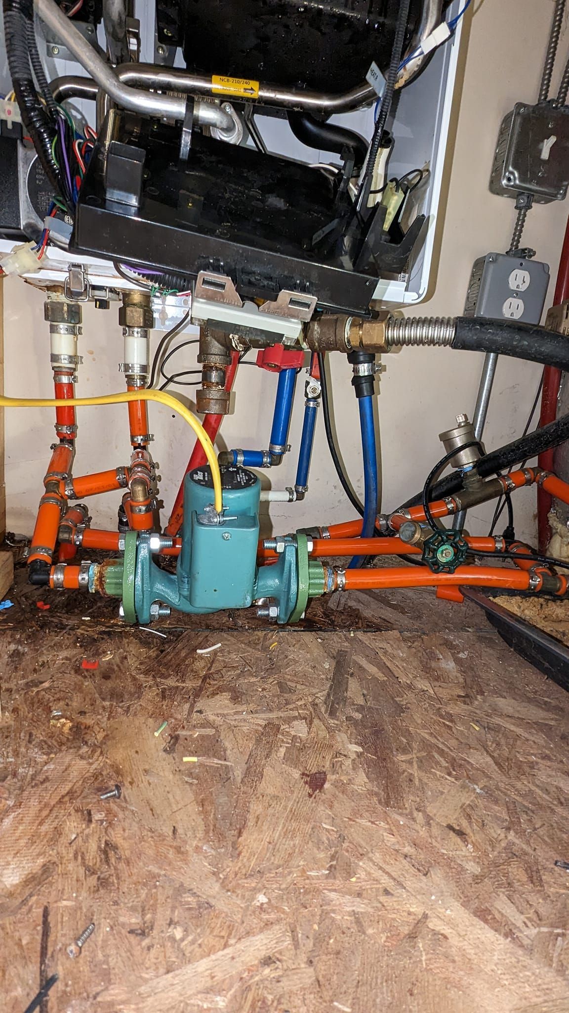 A bunch of pipes are connected to a wall in a room.