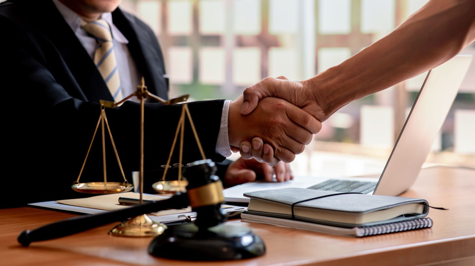 A man is shaking the hand of an attorney. A man is shaking the hand of an attorney.