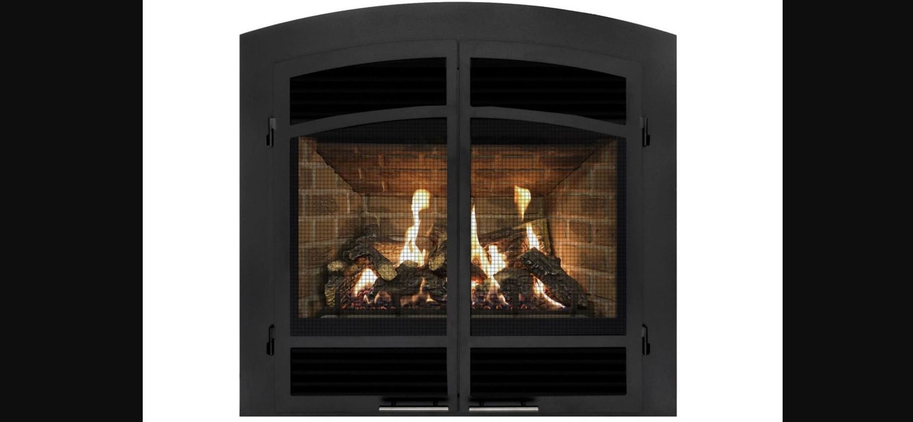 A fireplace with a black metal screen, burning flames and brick background.