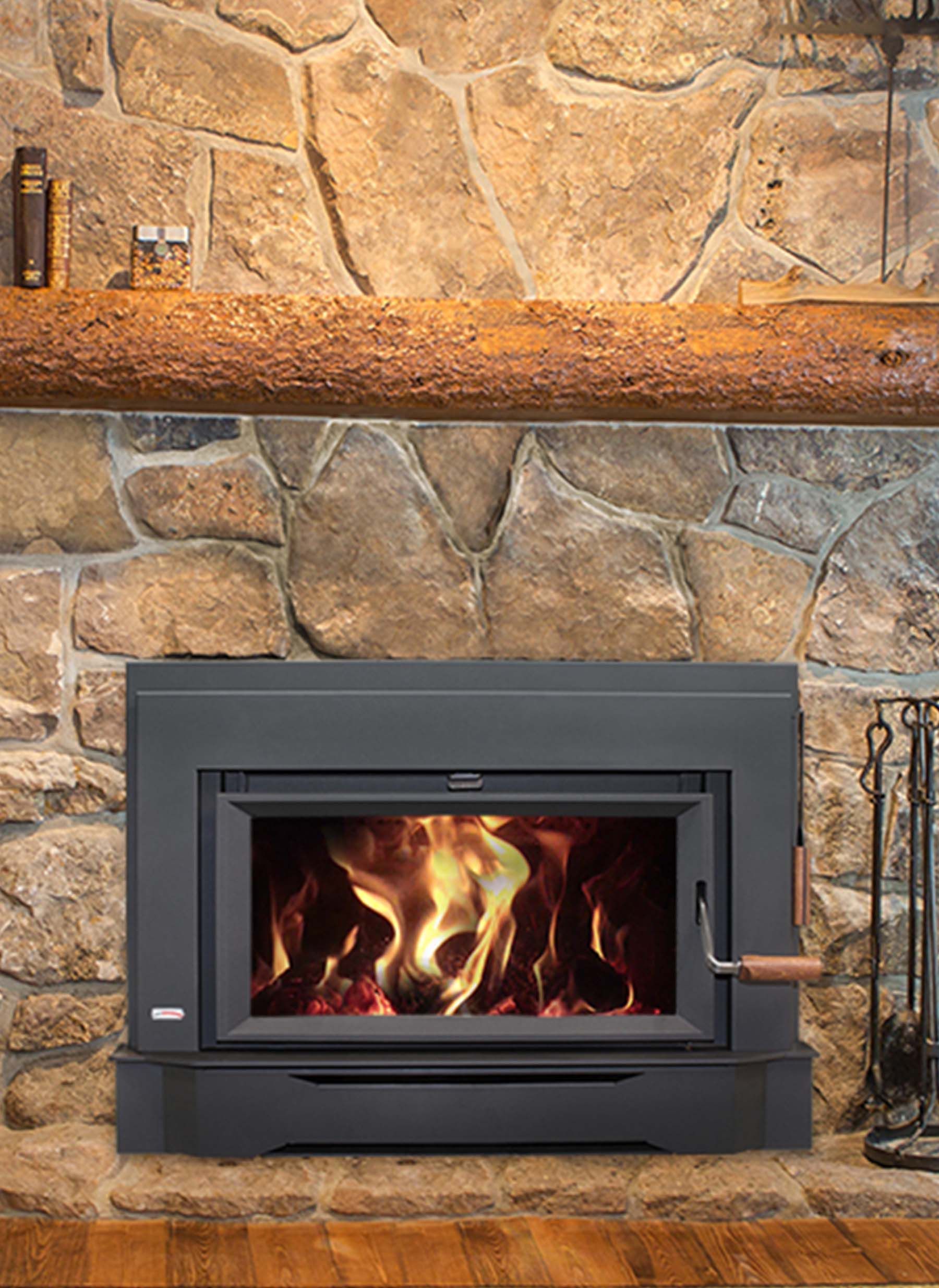 A fireplace with a fire burning inside is set in a stone wall. The fireplace has a black metal frame and a wooden handle.