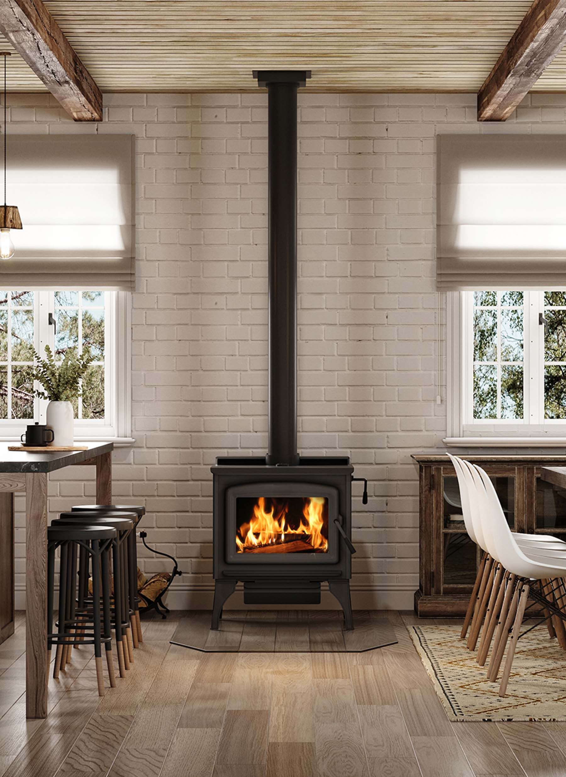 Wood-burning stove in a room with a white brick wall and two windows, flanked by furniture, and visible fire.