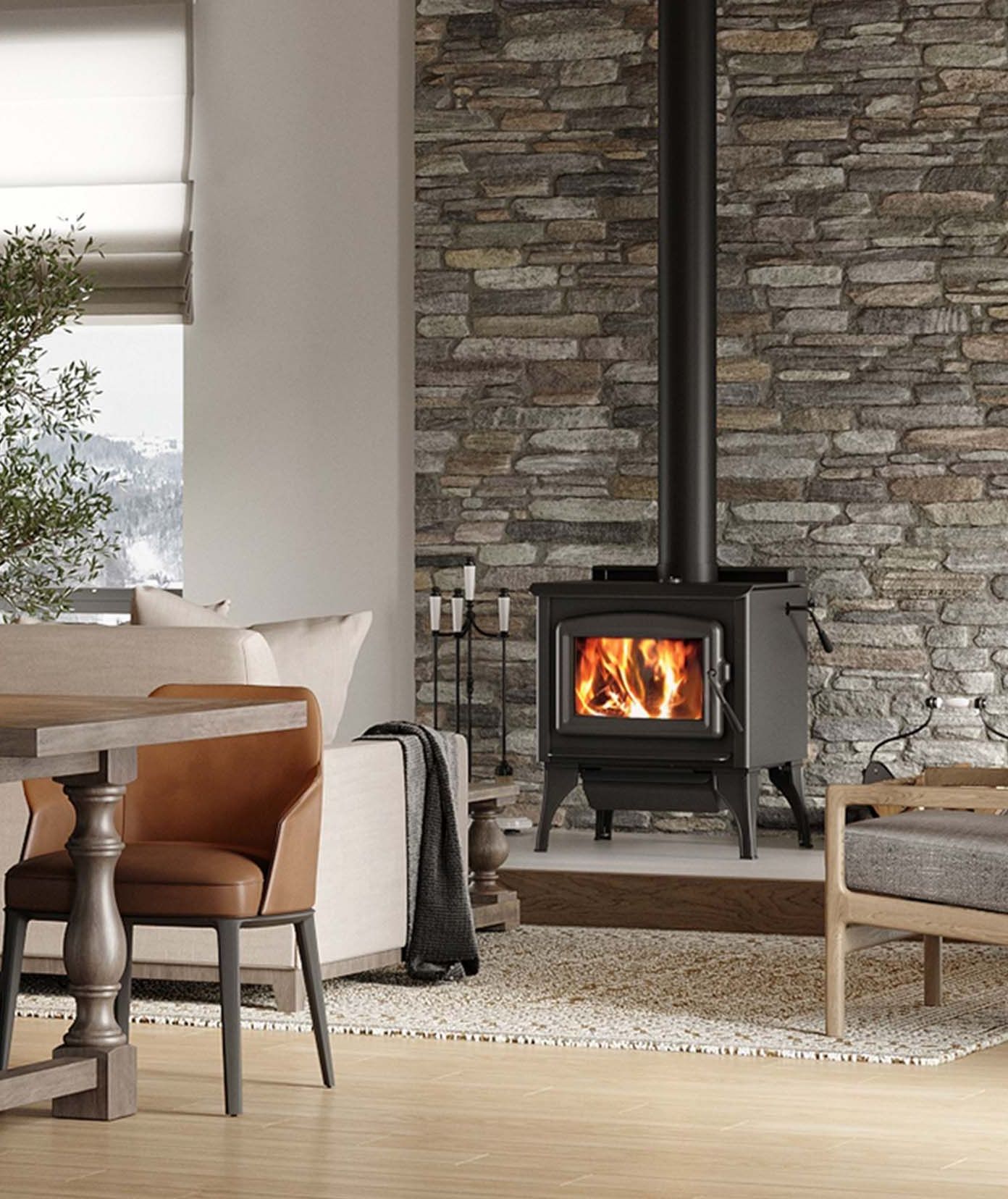 Cozy living room scene with a lit wood-burning stove against a stone wall, a brown leather chair, and a sofa.