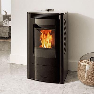 A black pellet stove with a glass door displaying flames. It sits indoors on a tiled floor.