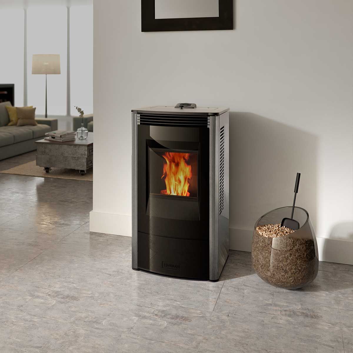A modern pellet stove with flames burning inside, set in a living room. A bin of pellets and a scoop sit next to the stove.