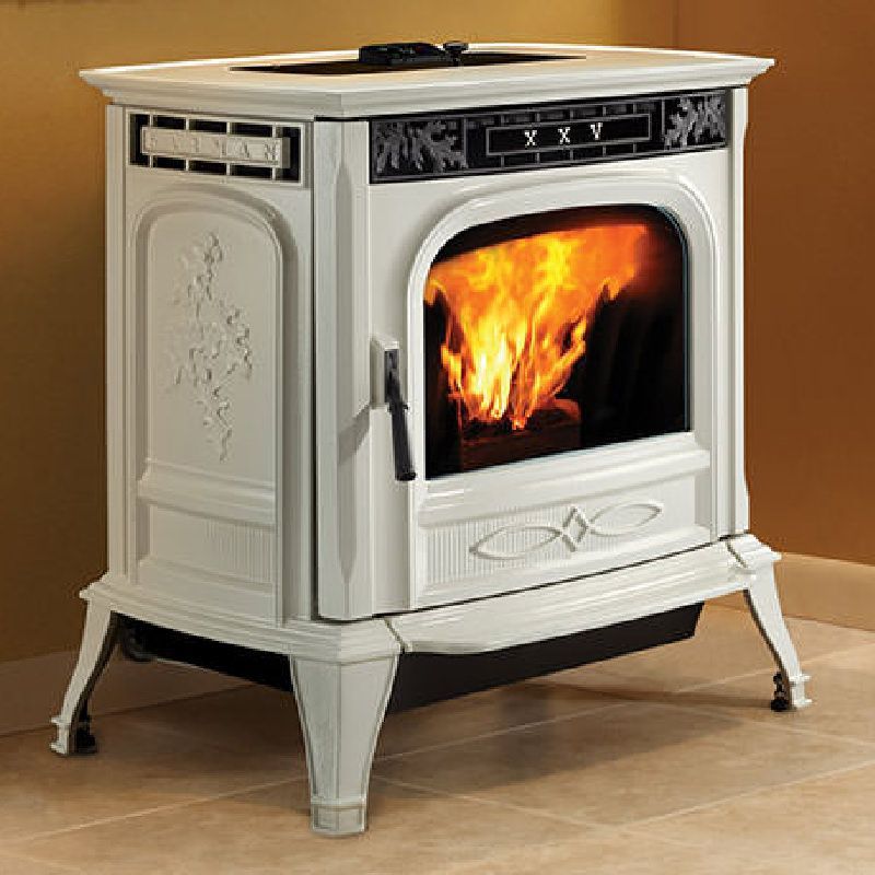 Cream-colored pellet stove with a roaring fire visible through a glass door, set in a home with beige walls and tile flooring.