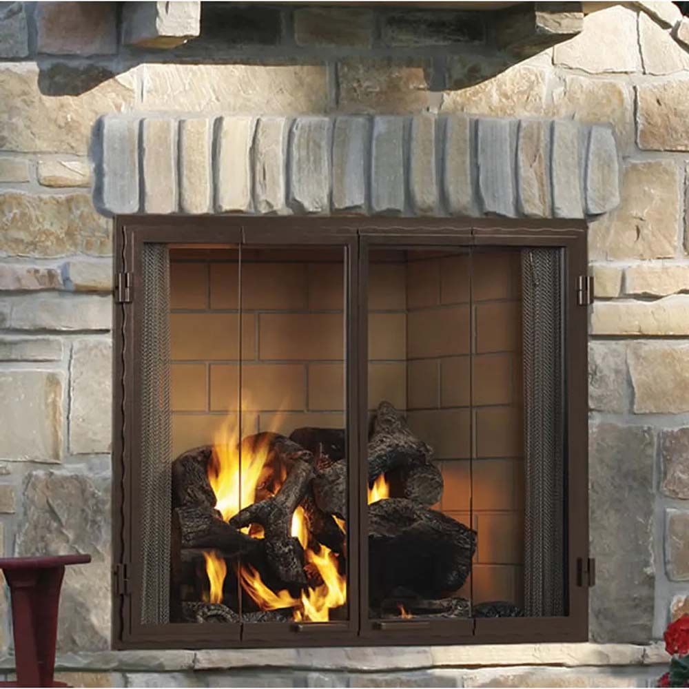 Cozy living room with fireplace flanked by two bookshelves filled with books and decor. Fire burning in the fireplace.