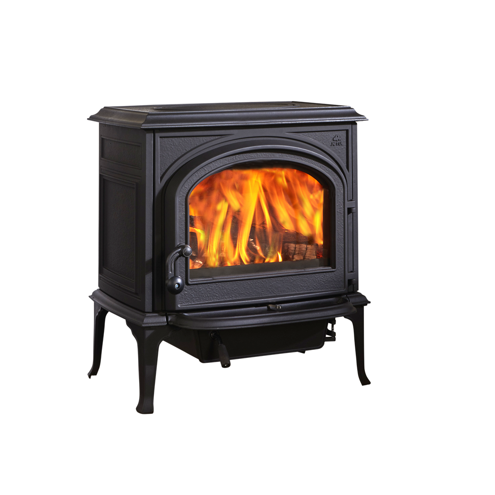 Black cast iron wood-burning stove with a fire burning inside. It has an arched glass door, a handle, and stands on four legs.