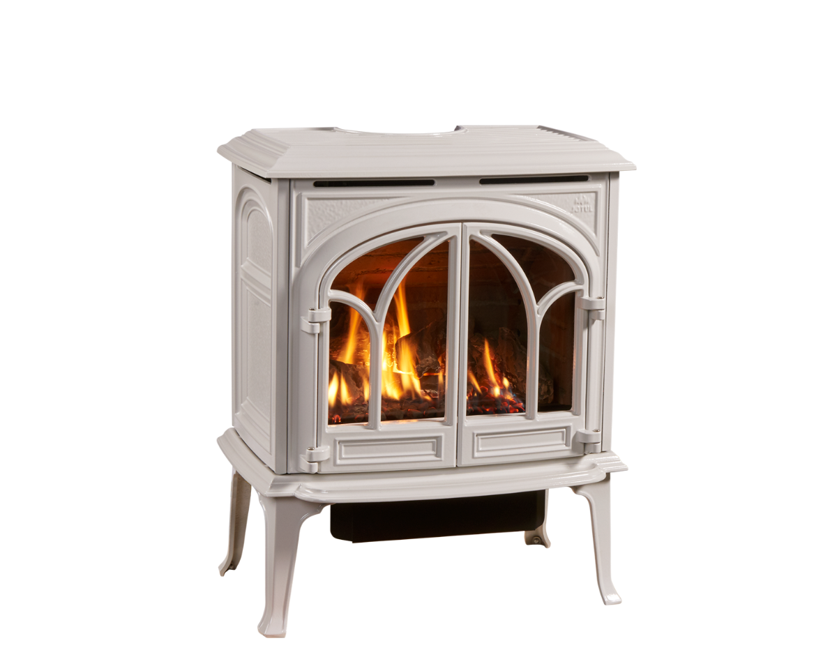 A white, freestanding gas fireplace with arched glass doors, flames visible inside.