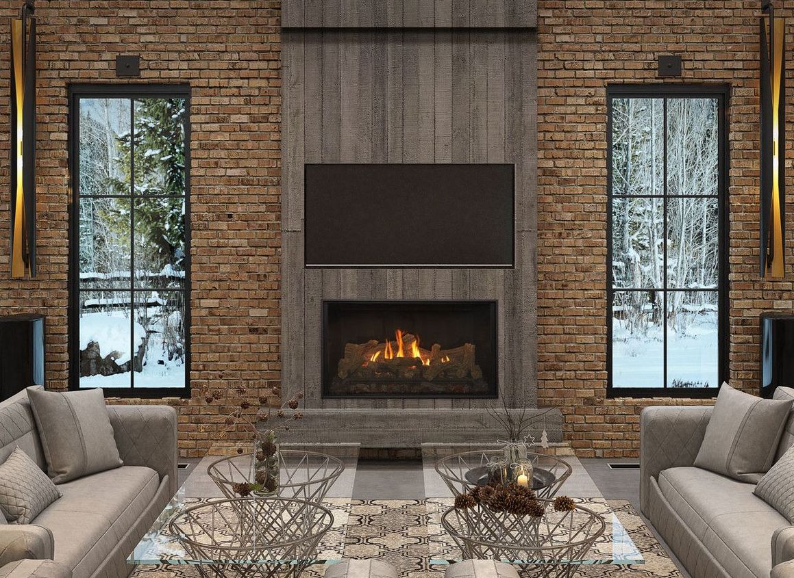 A cozy living room with a fireplace, TV, and winter views through two windows, flanked by speakers. Two sofas and glass tables complete the scene.
