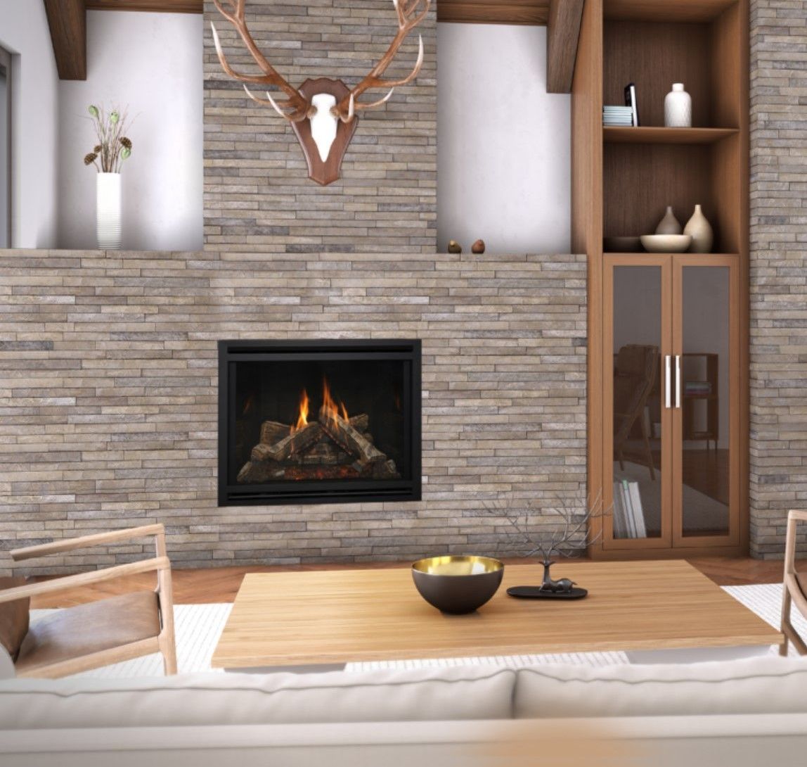 Fireplace with a stone facade, flanked by wooden shelving and a cabinet. Above the fireplace is a mounted deer head.