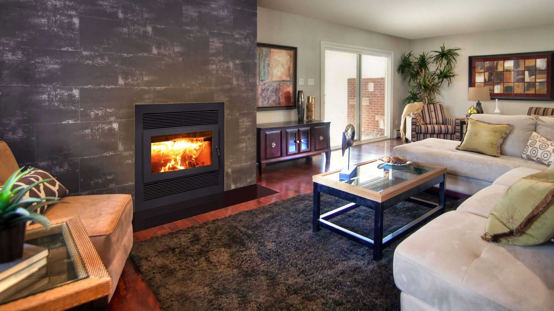 Living room with fireplace. The room features a modern fireplace, a beige sectional sofa, dark wood floors, and a large rug.