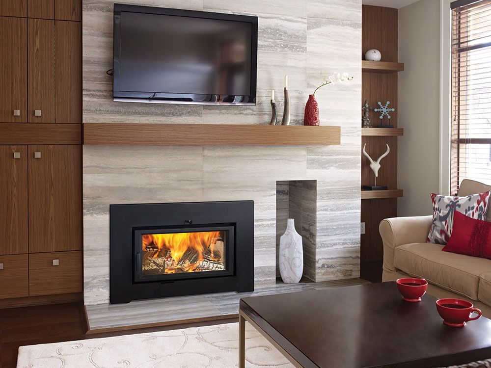 A modern living room with a fireplace, TV, and built-in shelves. The fireplace has a fire burning, and the room has a neutral color scheme with red accents.